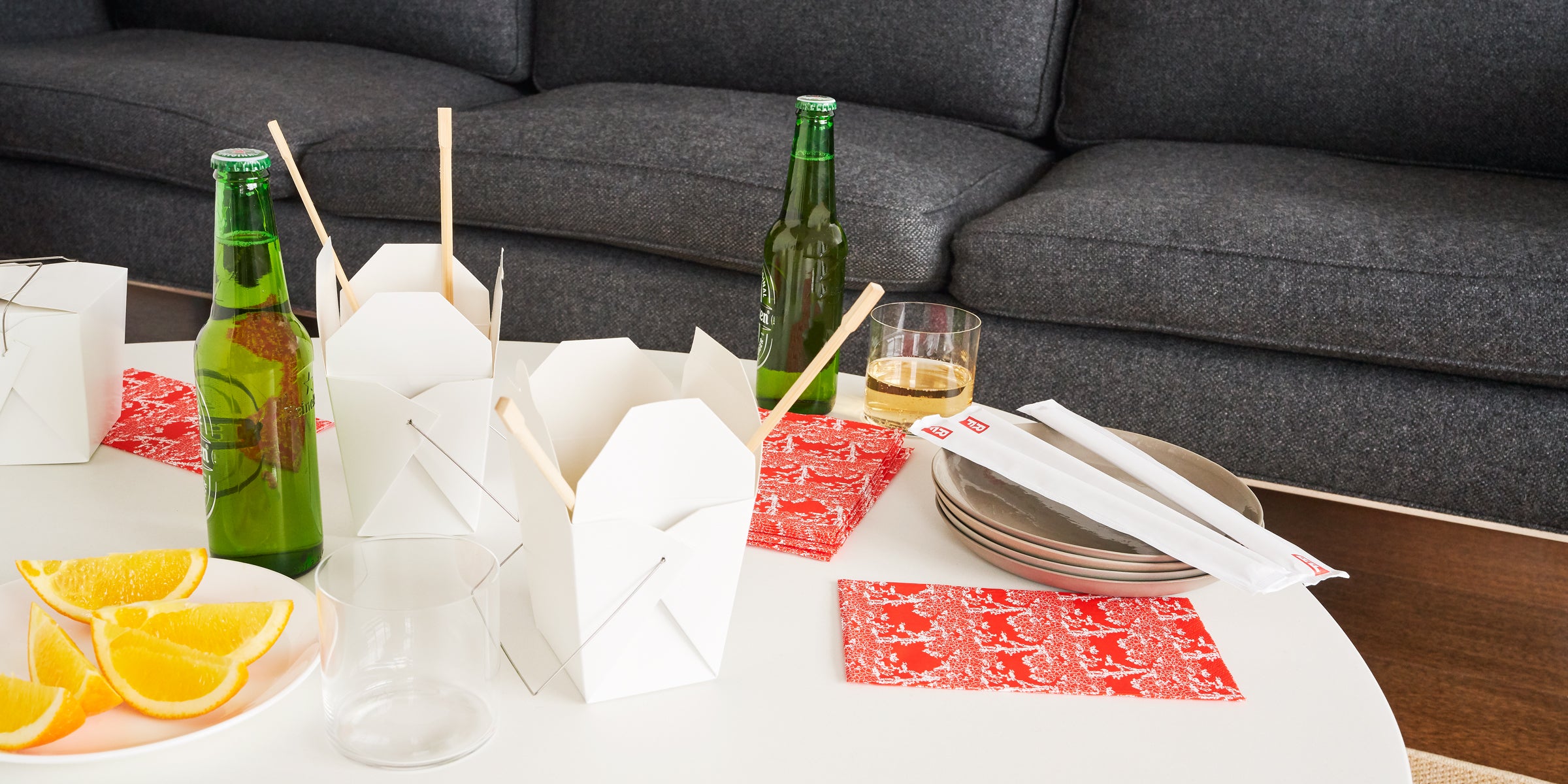 Orange/red guest towel napkin with white cherry tree pattern in casual entertaining setting