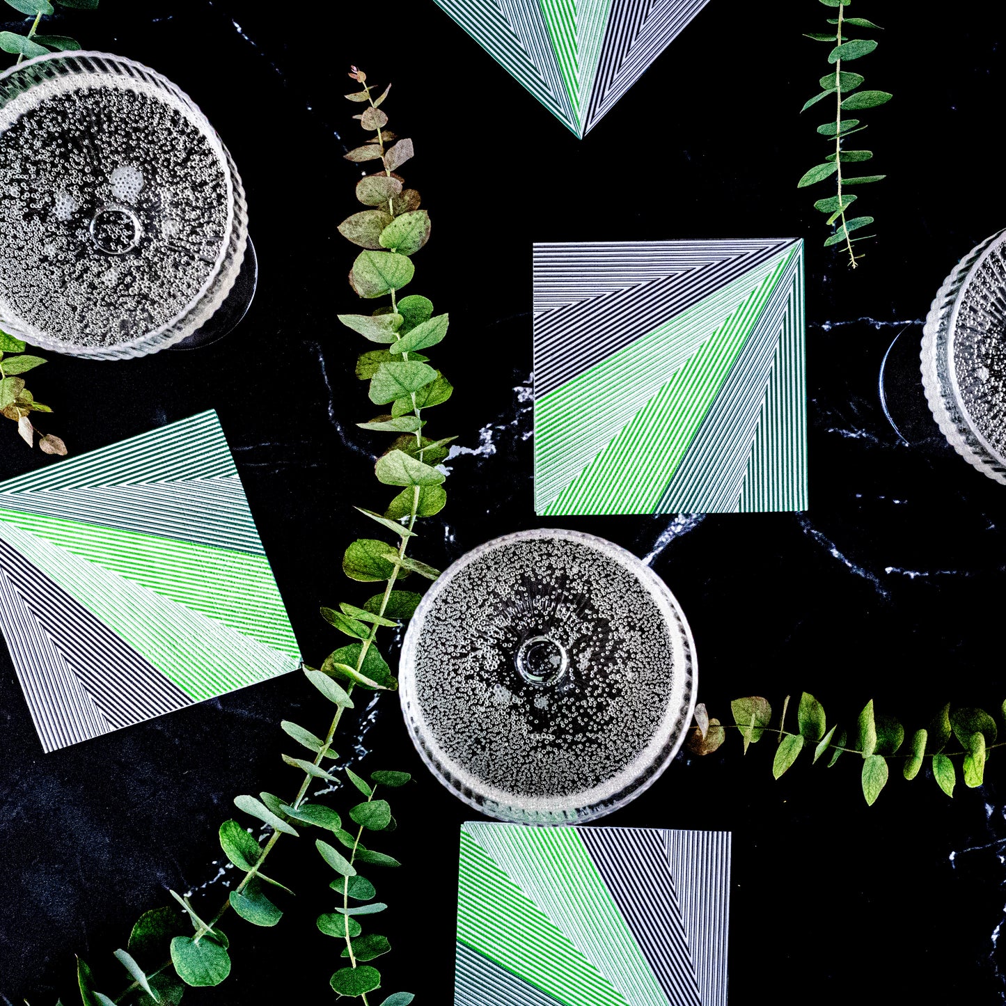 Green, black and white cocktail napkin with striped pattern