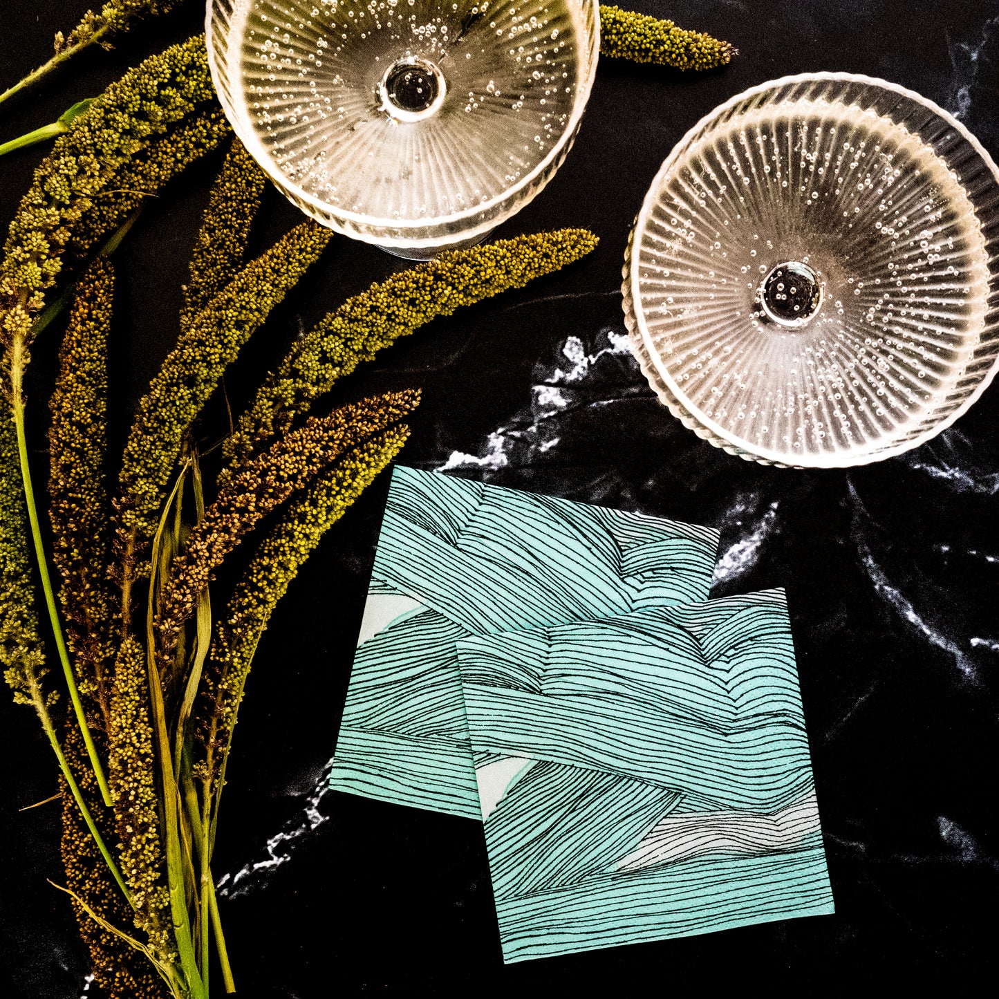 Green, black and off-white cocktail napkin with abstract pattern