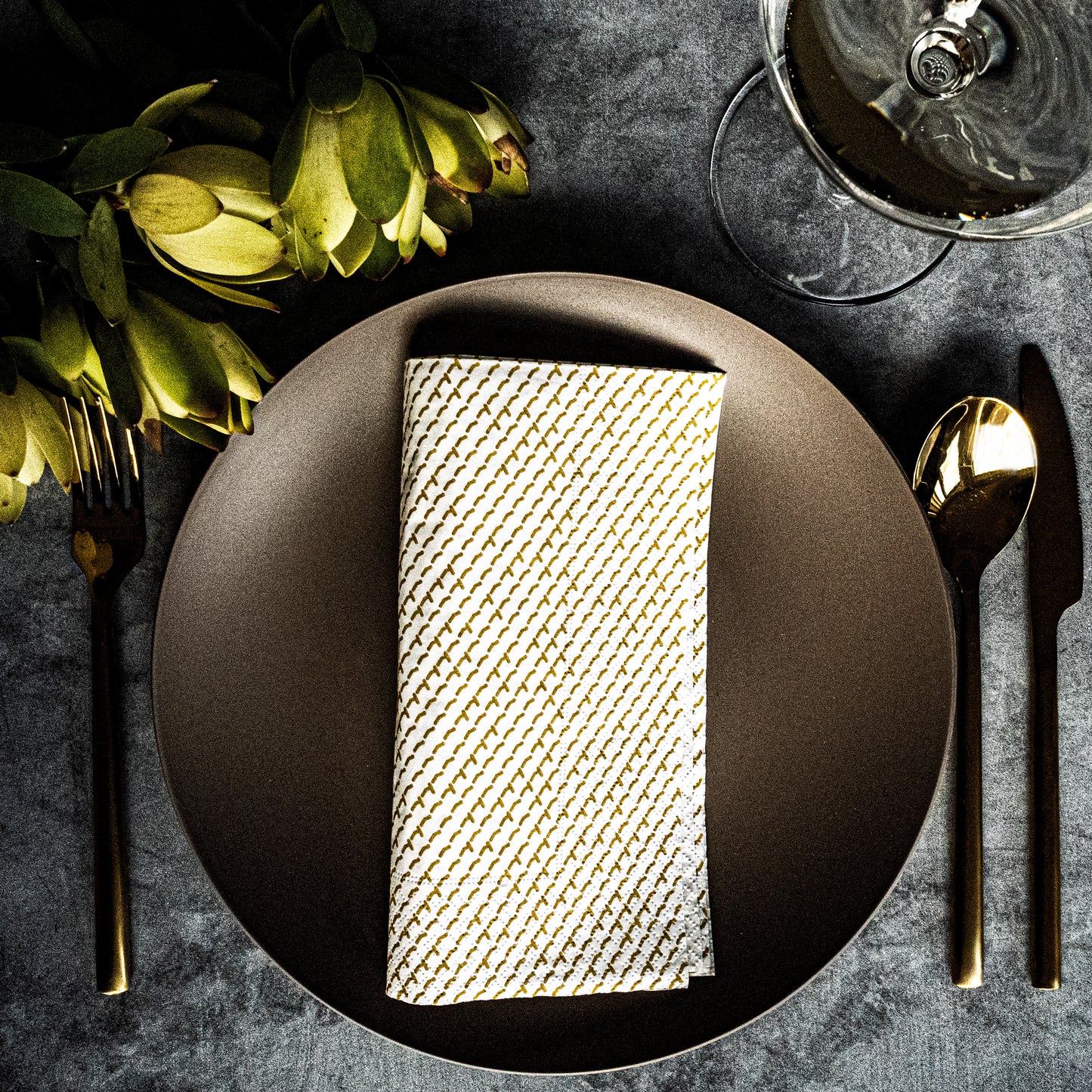 White dinner napkin with gold abstract pattern