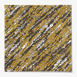 Gold, black and white dinner napkin with abstract pattern