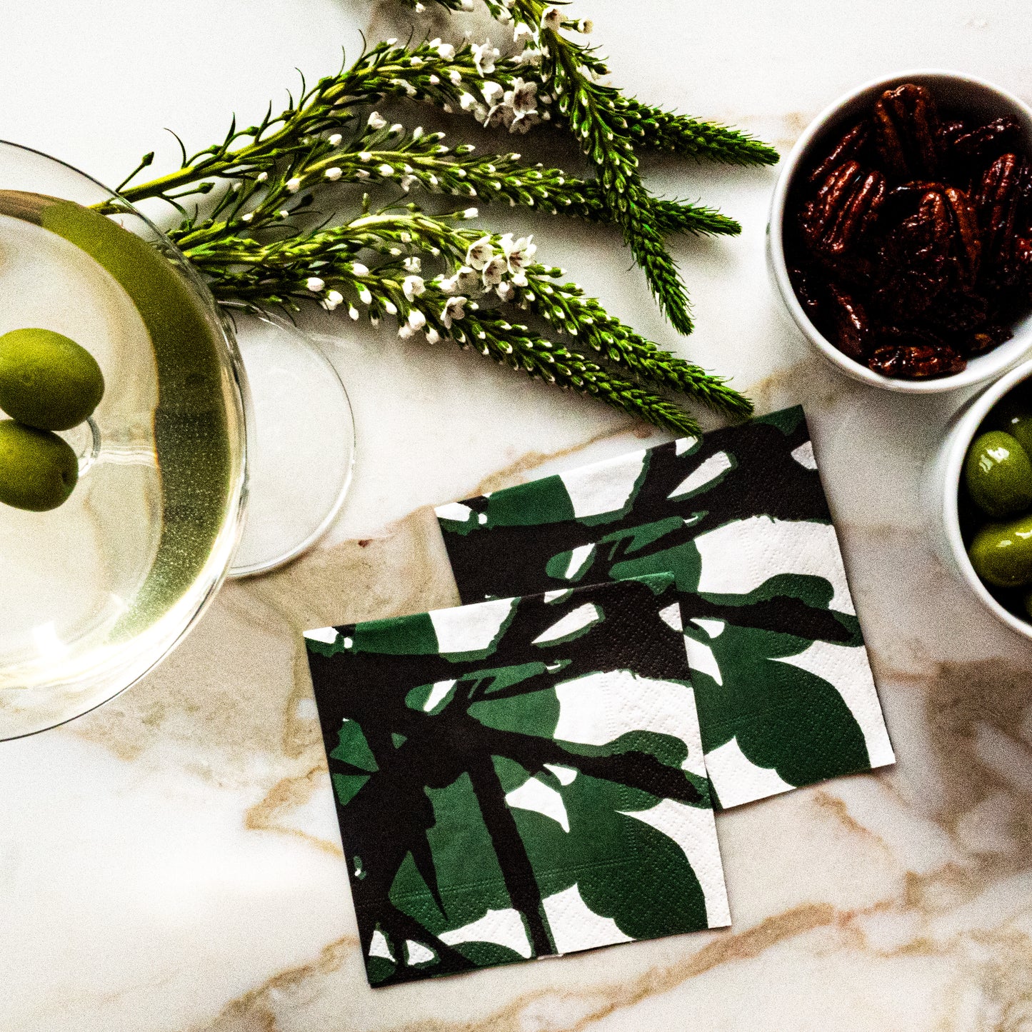 White cocktail napkin with green and black design