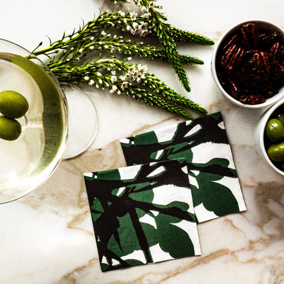 White cocktail napkin with green and black design