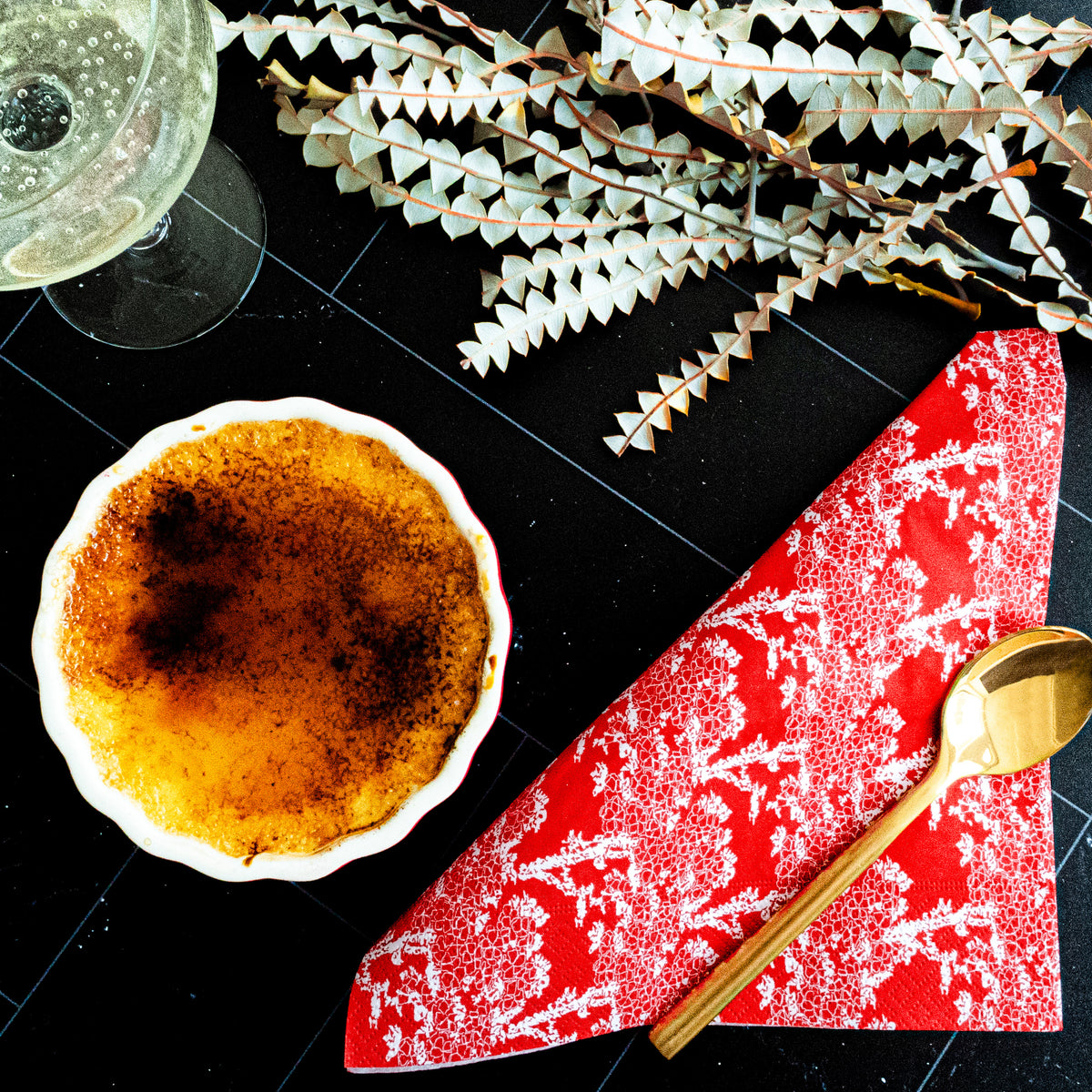 Orange/red dinner napkin with white cherry tree pattern