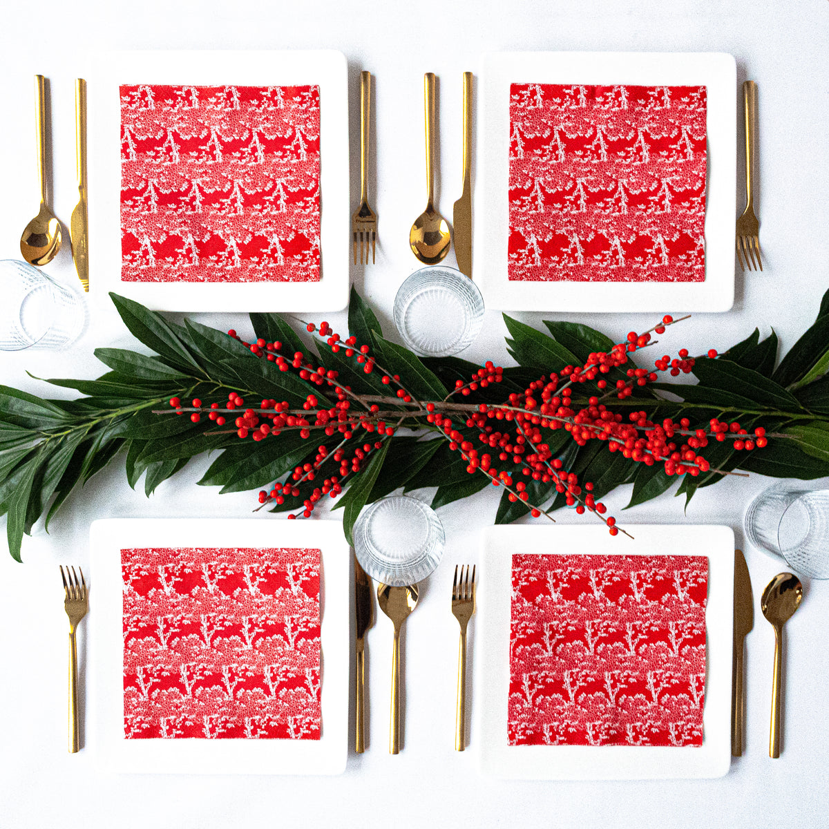 Orange/red dinner napkin with white cherry tree pattern
