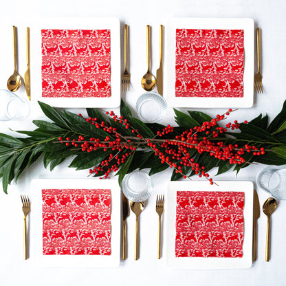 Orange/red dinner napkin with white cherry tree pattern