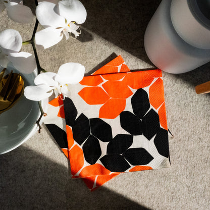 Beige dinner napkin with orange and black design