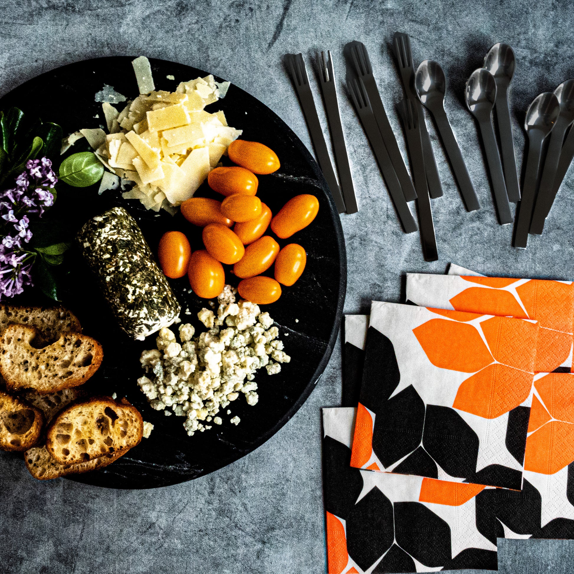 Beige cocktail napkin with orange and black design