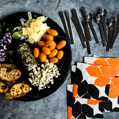 Beige cocktail napkin with orange and black design