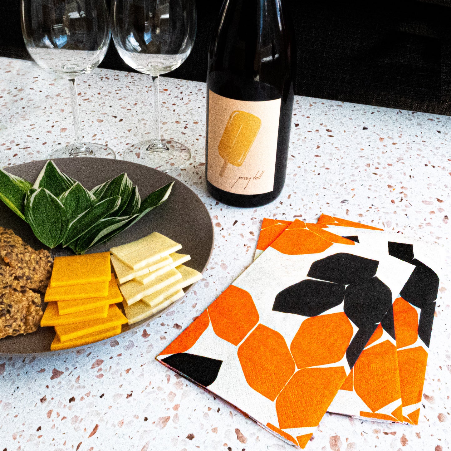 Beige guest towel napkin with orange and black design