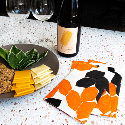 Beige guest towel napkin with orange and black design