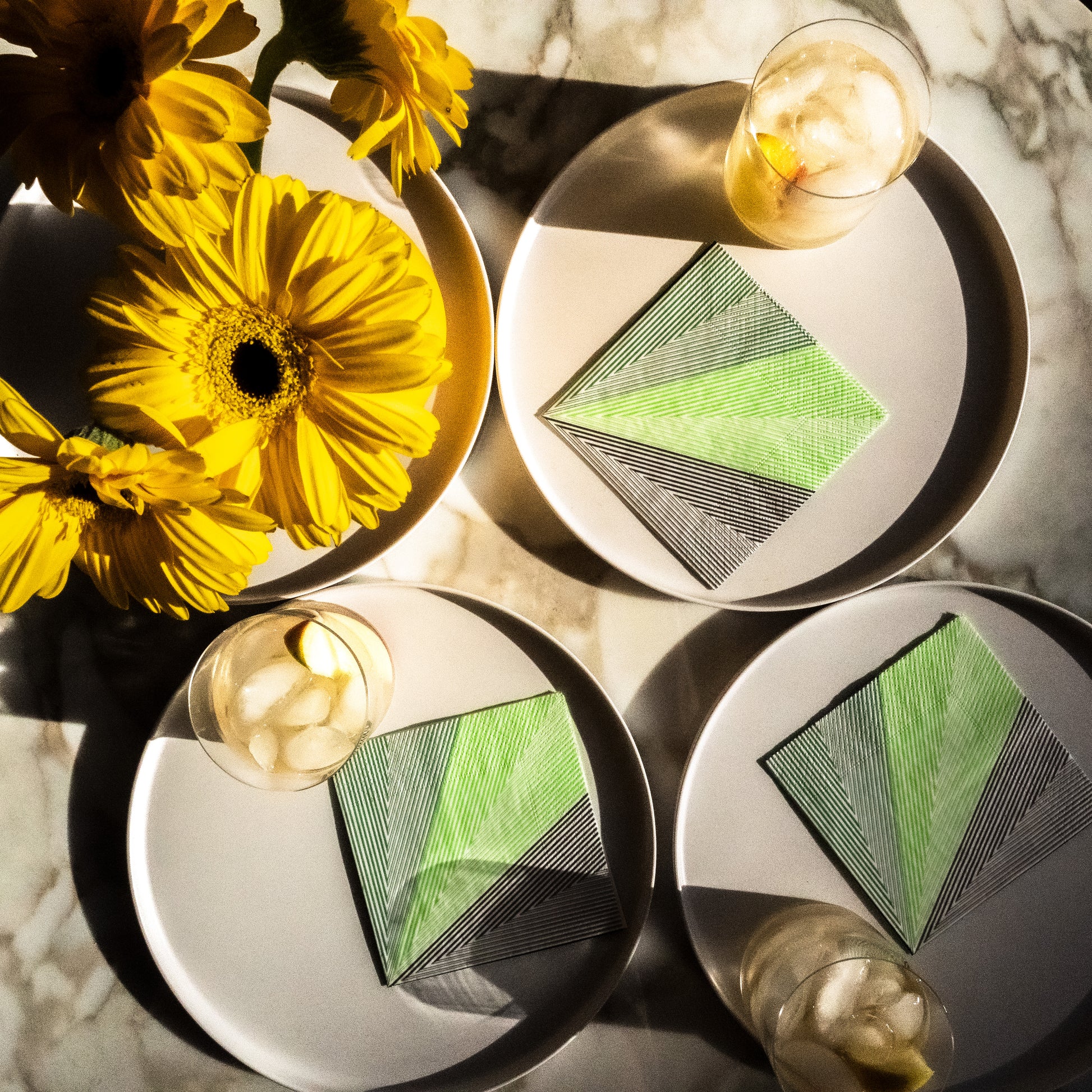 Green, black and white cocktail napkin with striped pattern