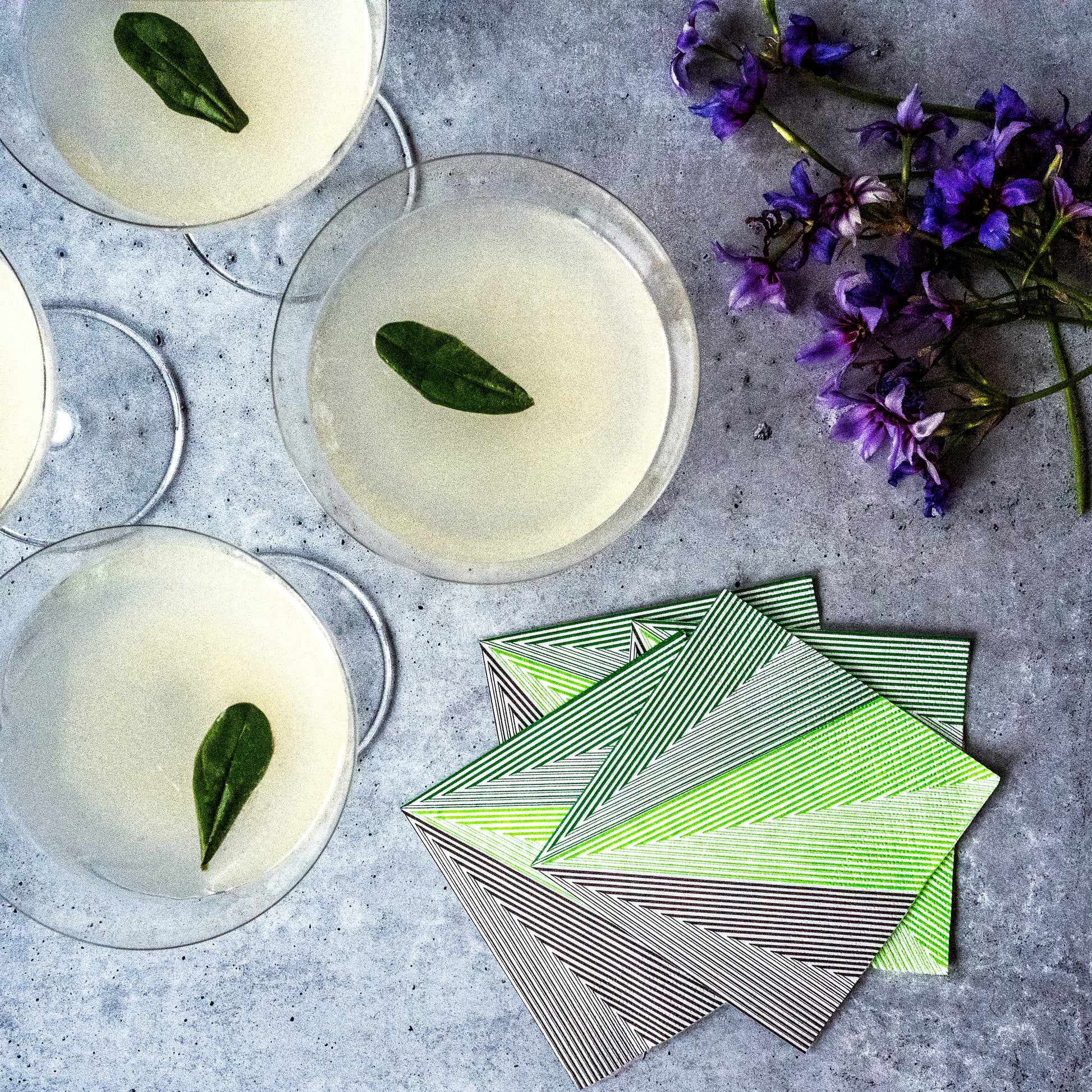 Green, black and white cocktail napkin with striped pattern