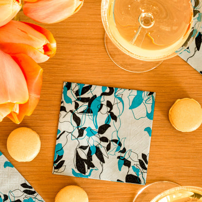 Teal, black and gray cocktail napkin with floral/leaf pattern