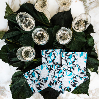 Teal, black and gray cocktail napkin with floral/leaf pattern