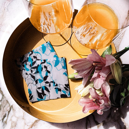 Teal, black and gray cocktail napkin with floral/leaf pattern