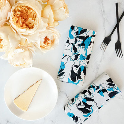 Teal, black and gray dinner napkin with floral/leaf pattern