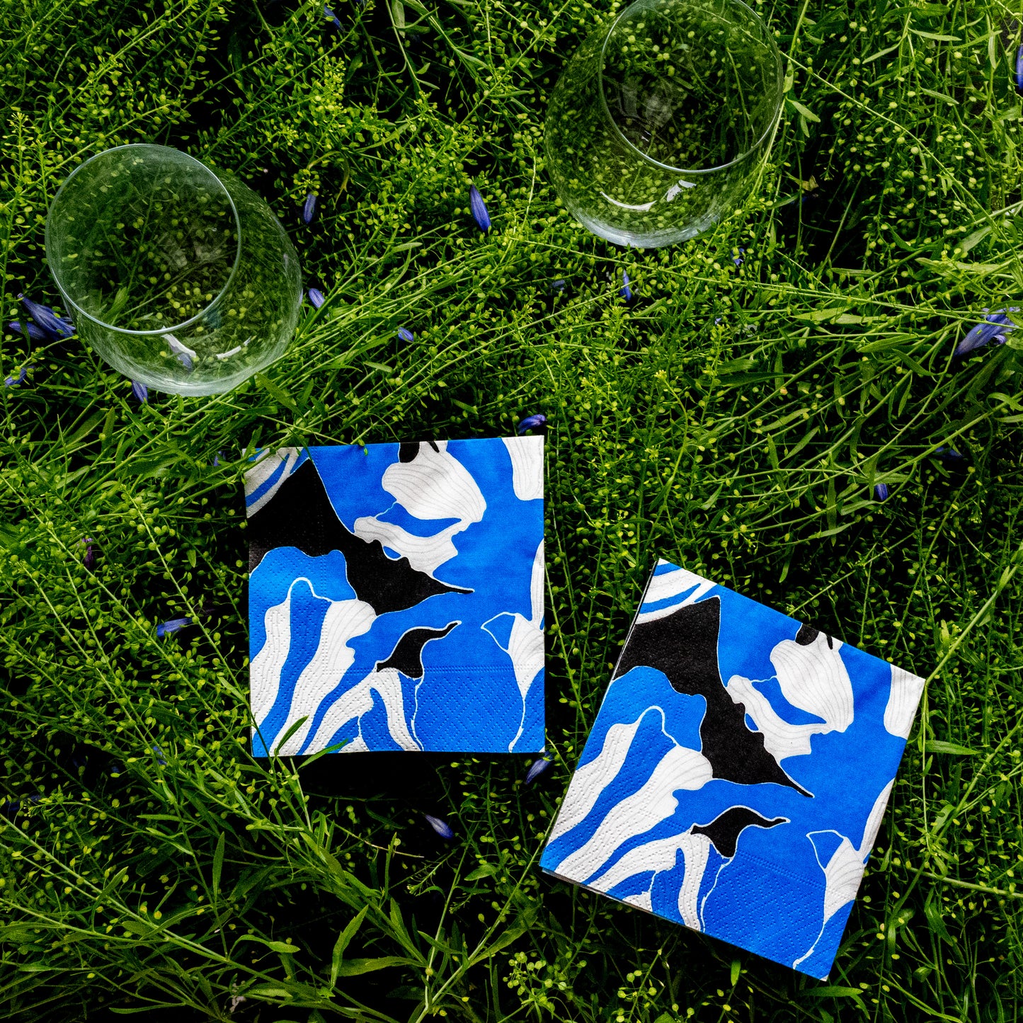 Blue, gray, white and black cocktail napkin with floral pattern