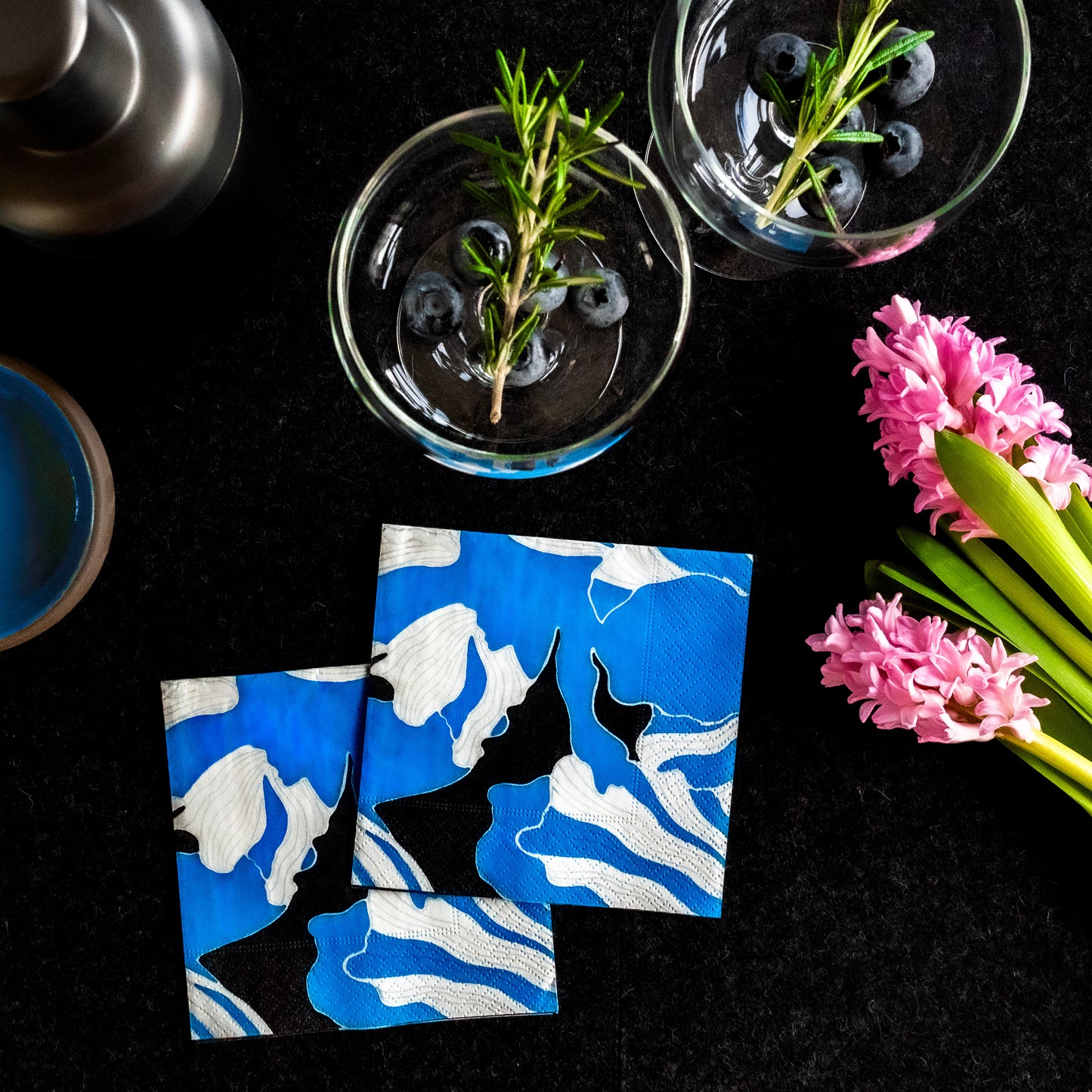 Blue, gray, white and black cocktail napkin with floral pattern