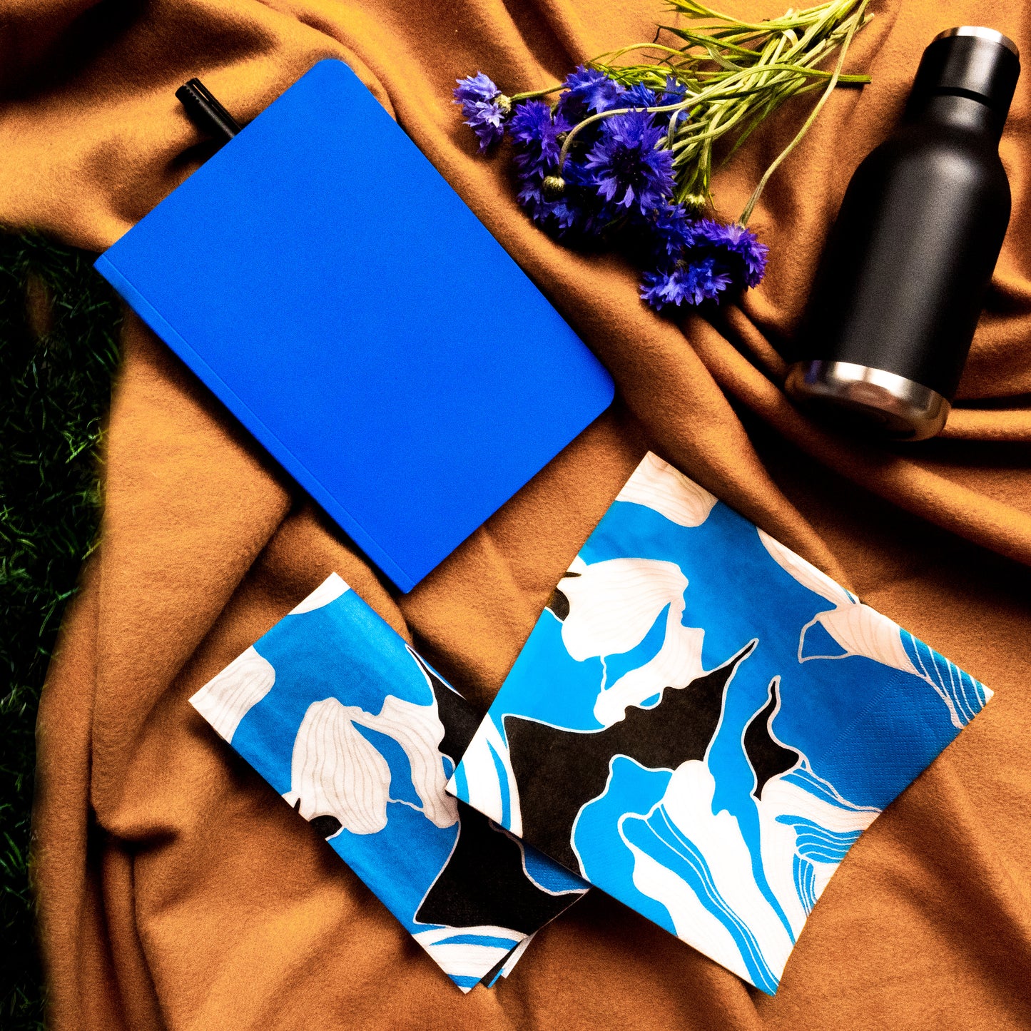 Blue, gray, white and black dinner napkin with floral pattern