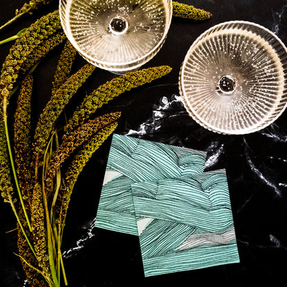 Green, black and off-white cocktail napkin with abstract pattern