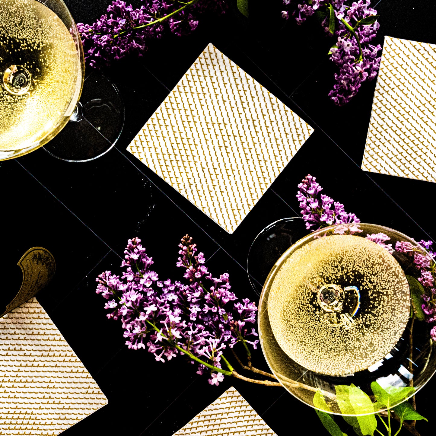 White cocktail napkin with gold abstract pattern