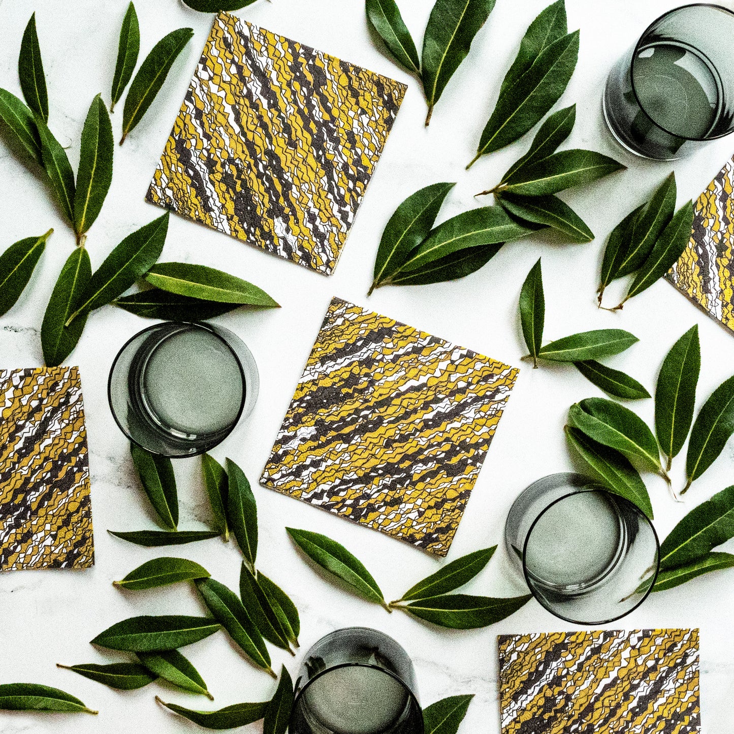 Gold, black and white cocktail napkin with abstract pattern