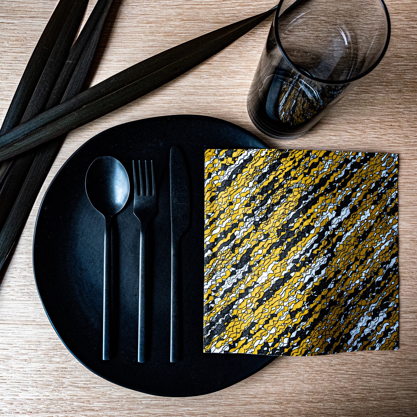 Gold, black and white dinner napkin with abstract pattern