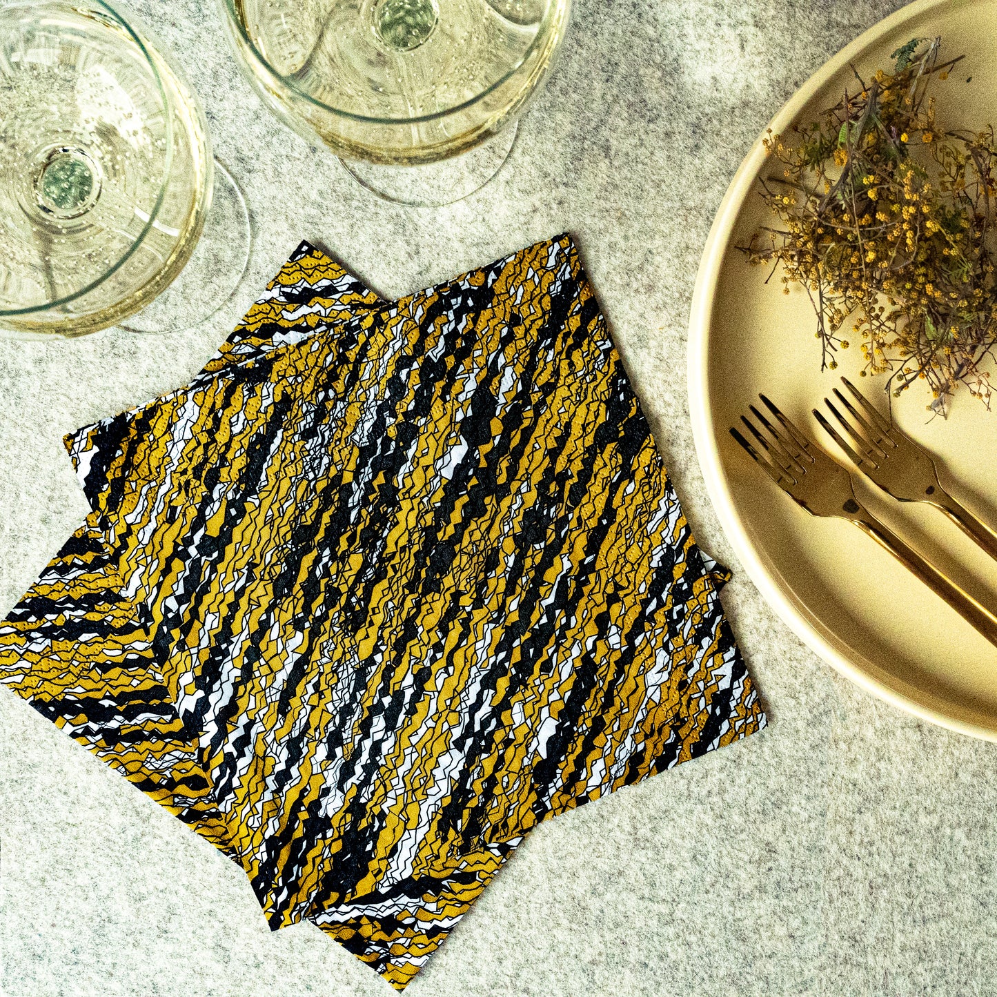 Gold, black and white dinner napkin with abstract pattern