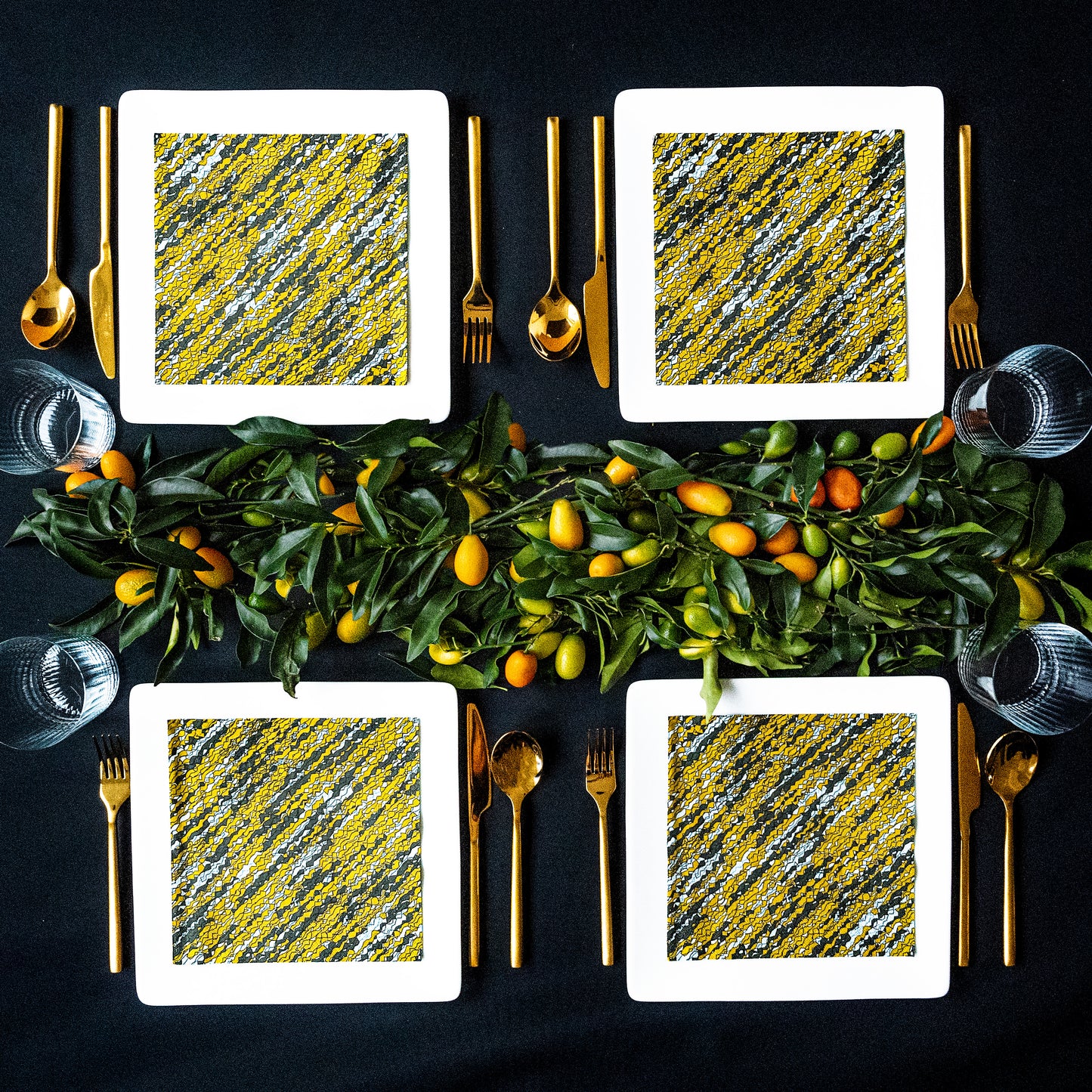 Gold, black and white dinner napkin with abstract pattern