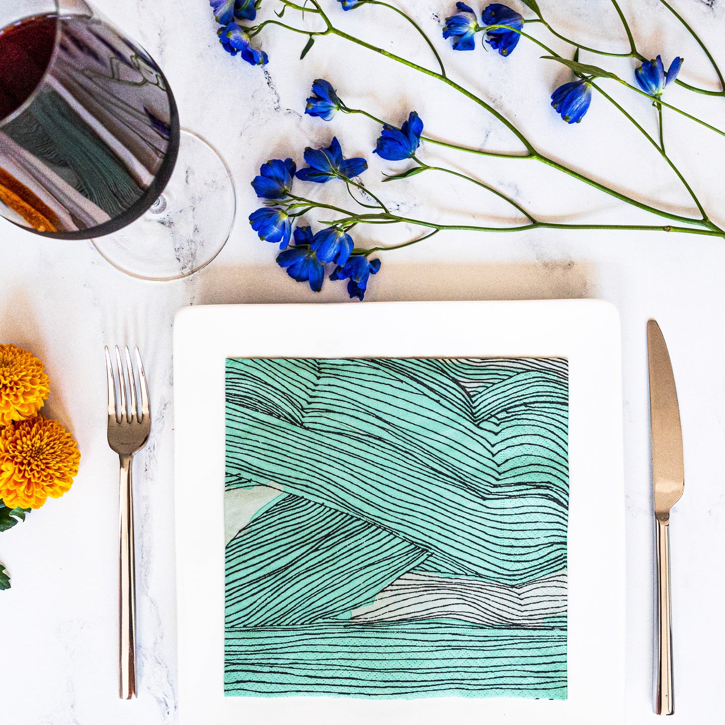 Green, black and off-white dinner napkin with abstract pattern