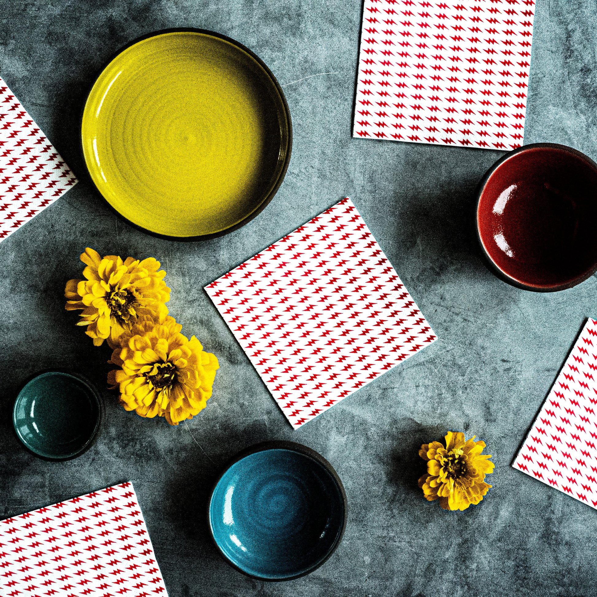 White cocktail napkin with red lightning bolt pattern