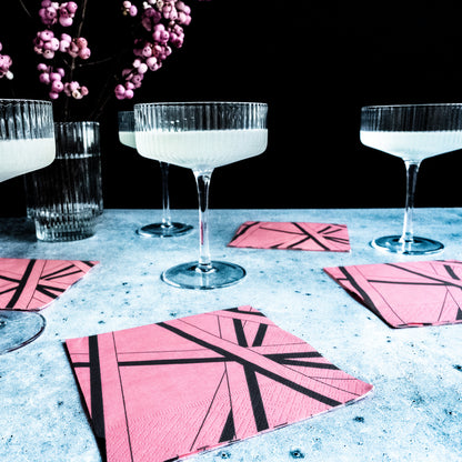 Pink cocktail napkin with black striped pattern