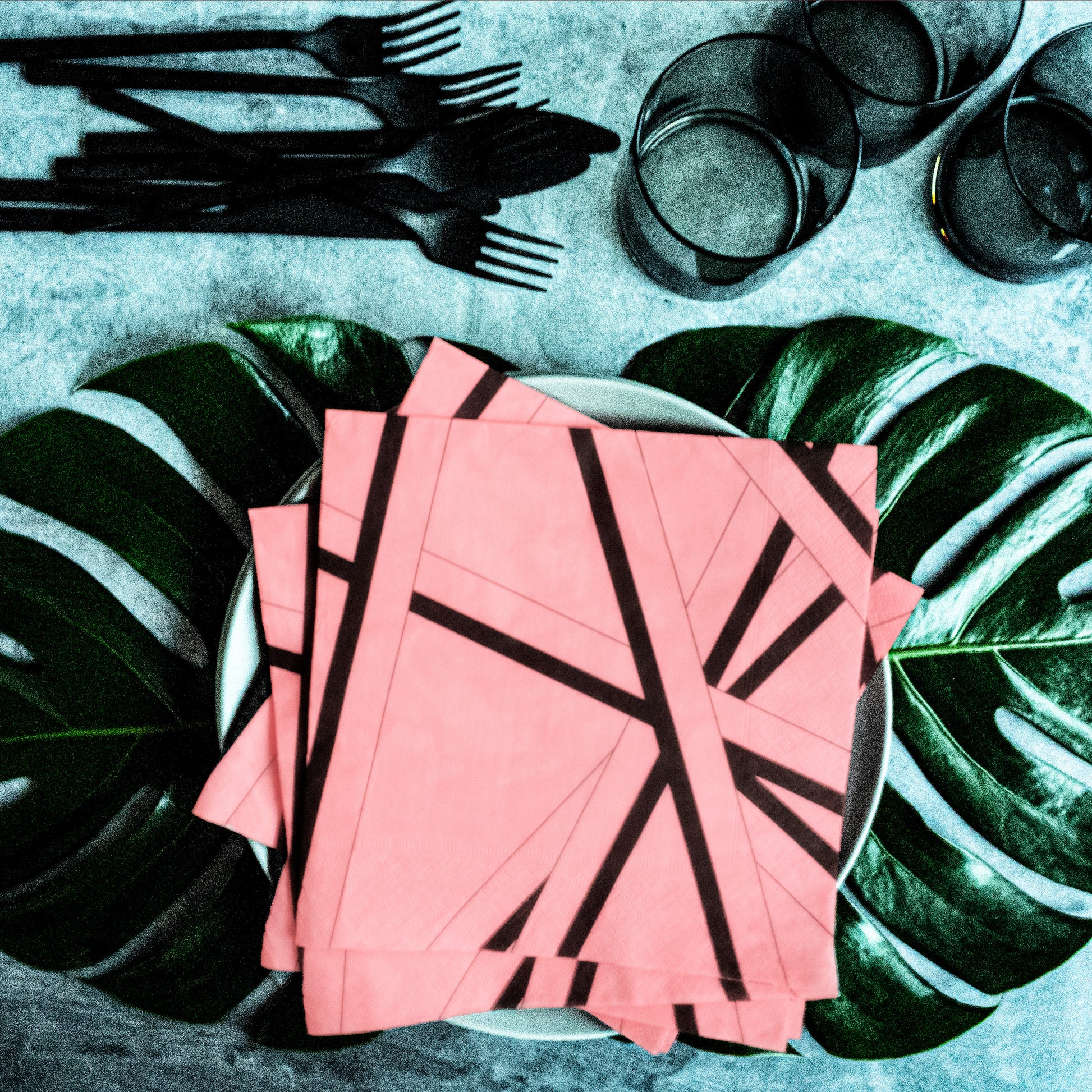 Pink dinner napkin with black striped pattern