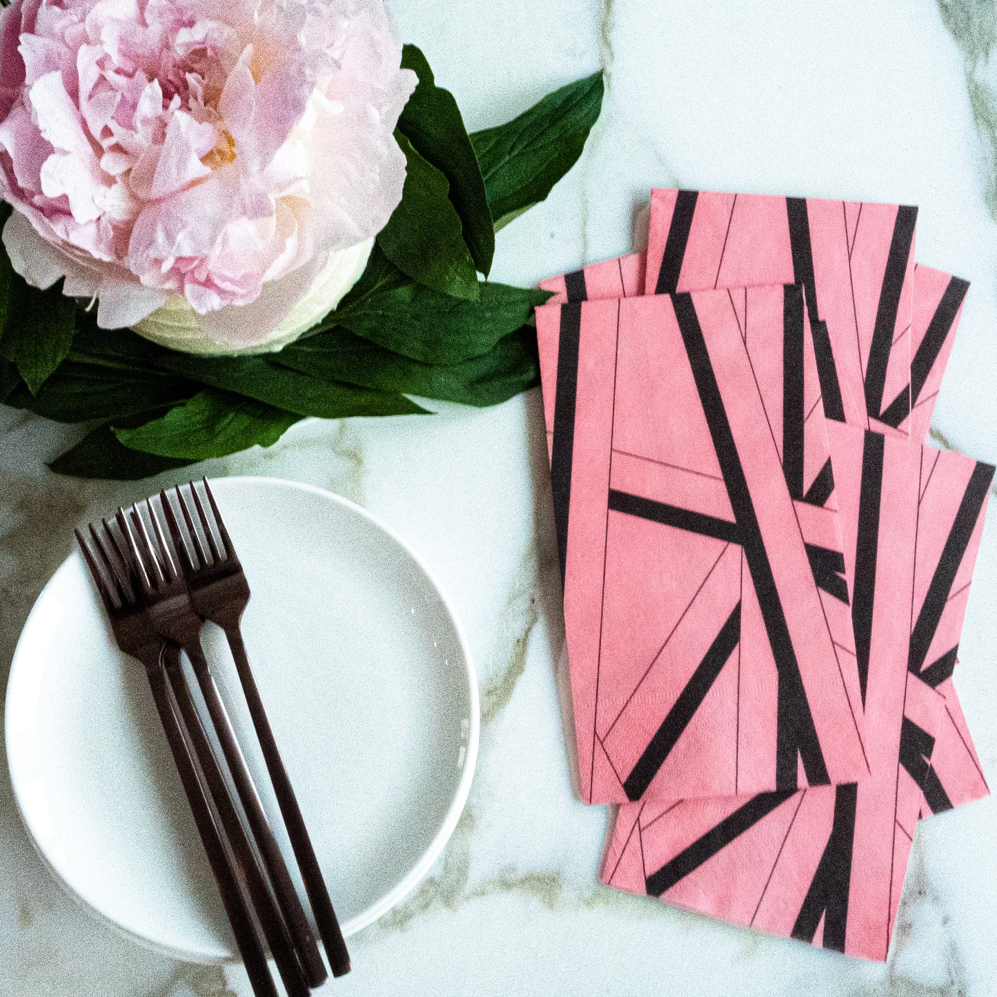 Pink guest towel napkin with black striped pattern
