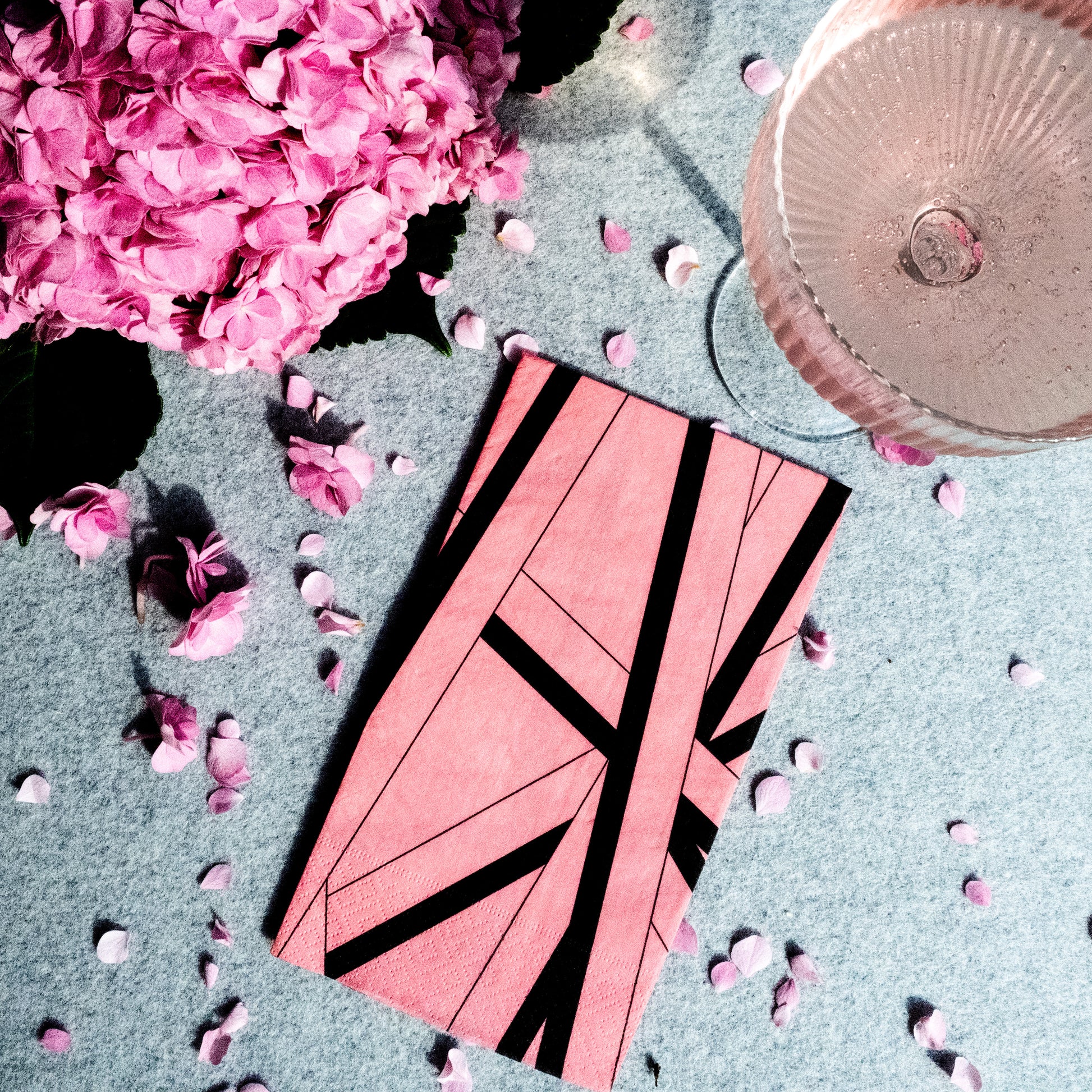 Pink guest towel napkin with black striped pattern