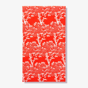 Orange/red guest towel napkin with white cherry tree pattern