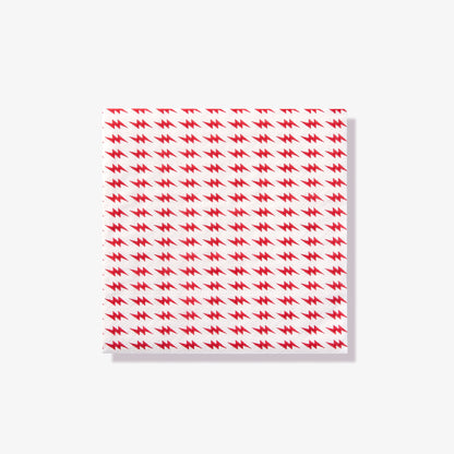 White cocktail napkin with red lightning bolt pattern