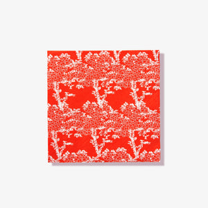 Orange/red cocktail napkin with white cherry tree pattern