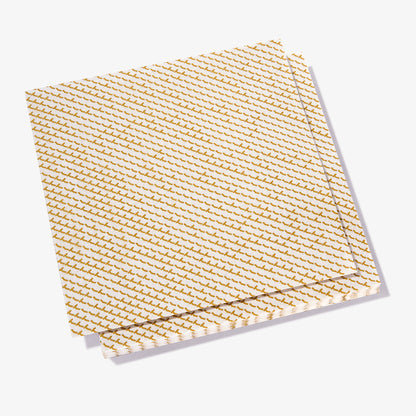 White dinner napkin with gold abstract pattern