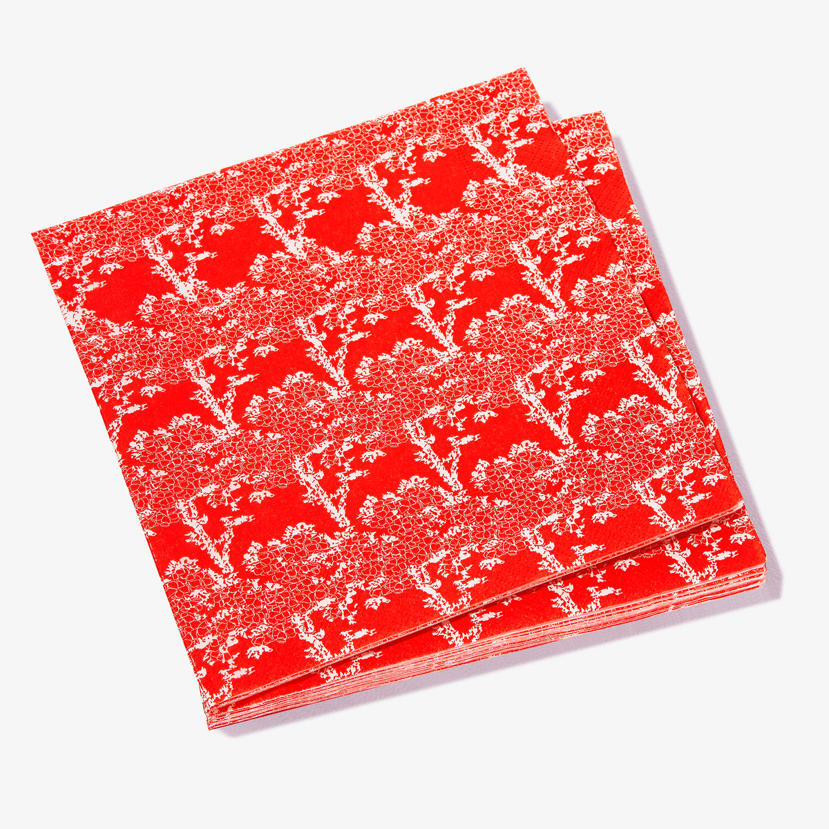 Orange/red dinner napkin with white cherry tree pattern
