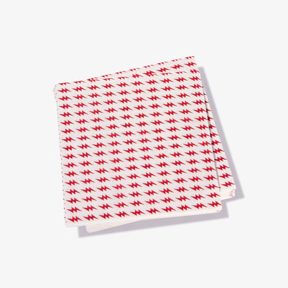 White cocktail napkin with red lightning bolt pattern