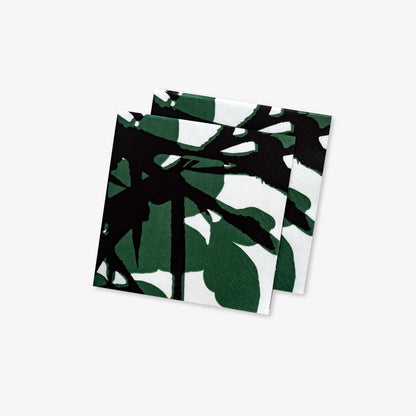 White cocktail napkin with green and black design