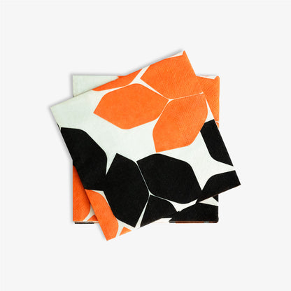 Beige cocktail napkin with orange and black design