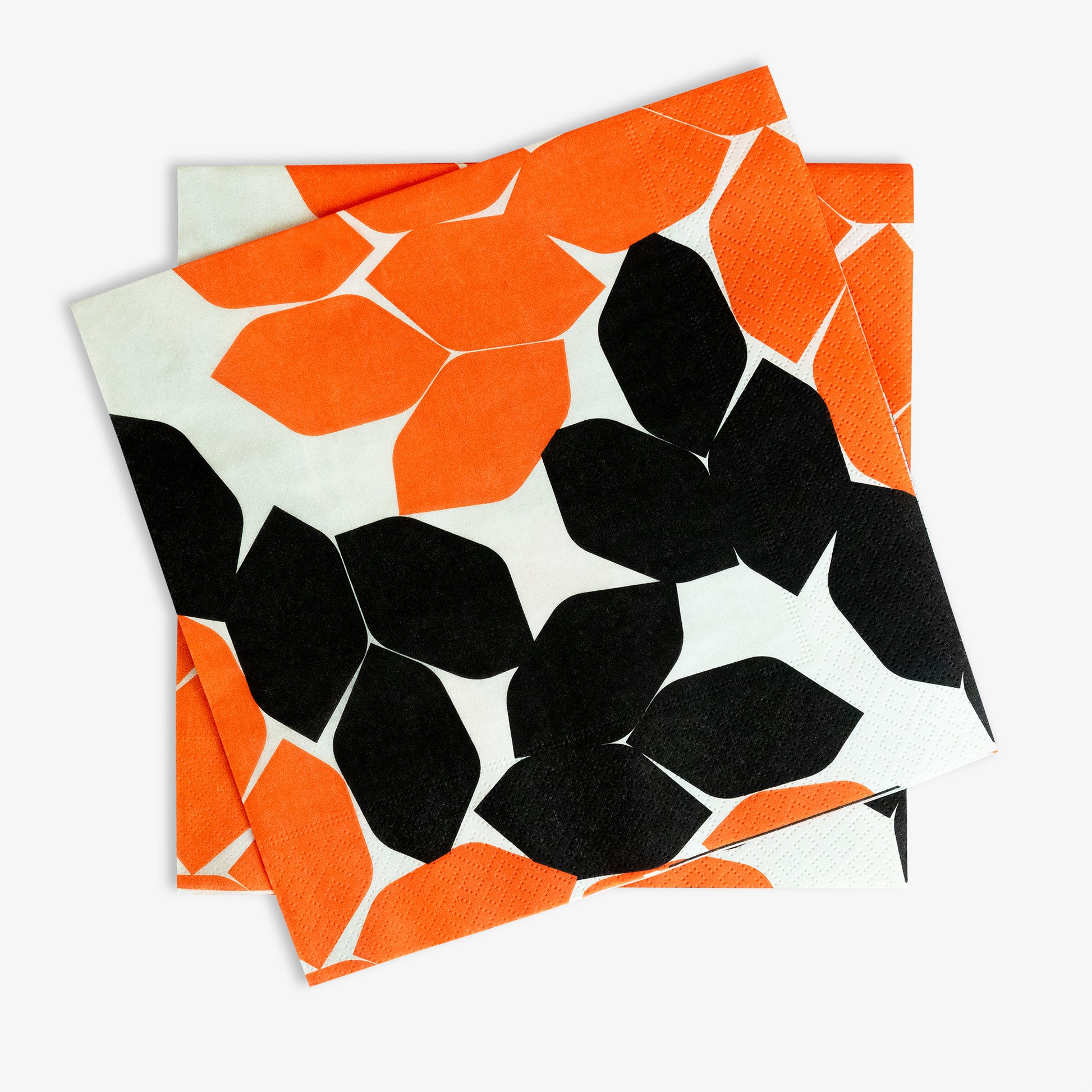 Beige dinner napkin with orange and black design