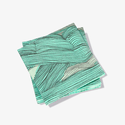 Green, black and off-white cocktail napkin with abstract pattern