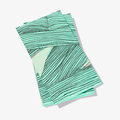 Green, black and off-white guest towel napkin with abstract pattern