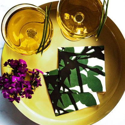 White cocktail napkin with green and black design