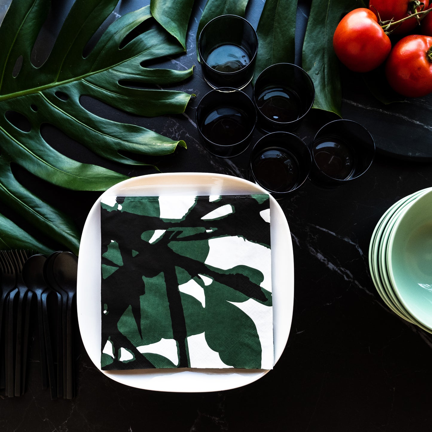White dinner napkin with green and black design