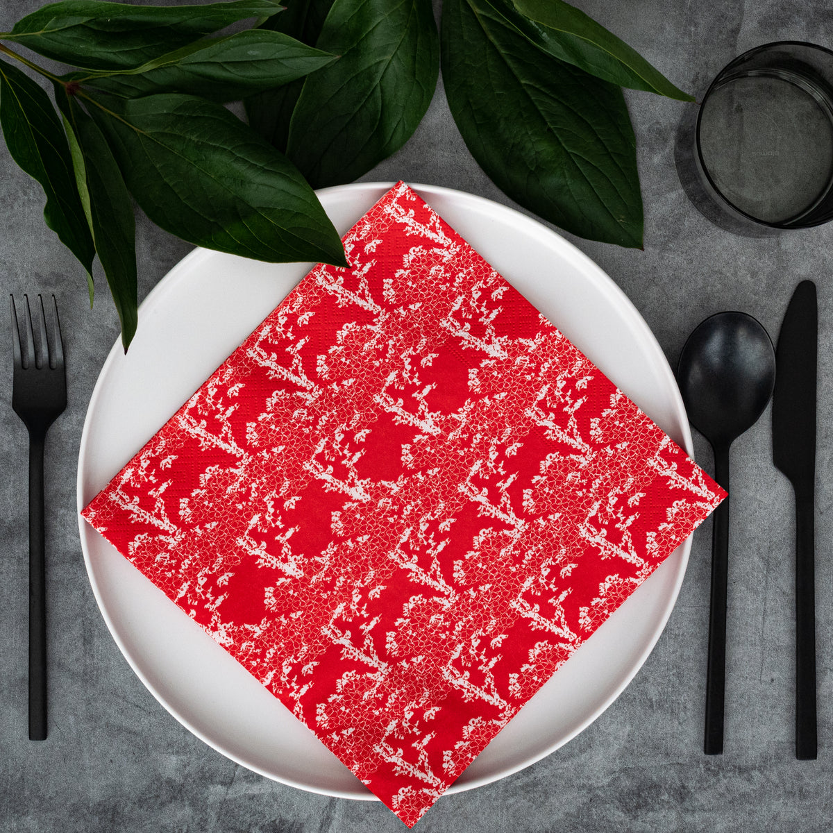 Orange/red dinner napkin with white cherry tree pattern